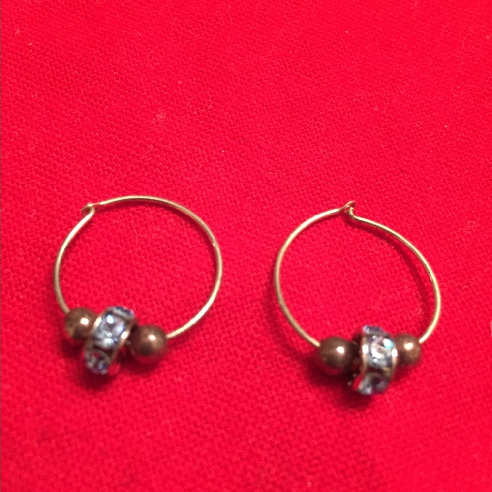 Gold earrings with gold balls and blue crystals